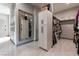 Open walk-in closet with custom cabinets, full-length mirror, and tiled floor at 7880 Dana Point Ct, Las Vegas, NV 89117