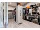 Spacious walk-in closet featuring custom shelving, storage cabinets, and ample hanging space at 7880 Dana Point Ct, Las Vegas, NV 89117