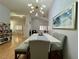 Spacious dining area with marble table and modern light fixture, open to living room at 8116 Sedona Sunset Dr, Las Vegas, NV 89128