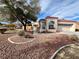 One-story home with desert landscaping, a gated entry, and a two-car garage at 8116 Sedona Sunset Dr, Las Vegas, NV 89128