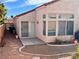 House exterior with sliding glass doors and a covered patio at 8116 Sedona Sunset Dr, Las Vegas, NV 89128