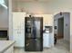 Kitchen boasts stainless steel refrigerator and white cabinetry at 8116 Sedona Sunset Dr, Las Vegas, NV 89128