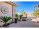 Front entrance with sun and moon art and potted plants at 816 Sandsprings St, Henderson, NV 89011