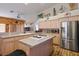 Kitchen with island, stainless steel appliances, and light wood cabinets at 816 Sandsprings St, Henderson, NV 89011