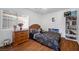 Bedroom with queen bed and wooden dresser at 8529 Copper Knoll Ave, Las Vegas, NV 89129