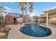 Inviting kidney shaped pool with waterfall and patio at 8529 Copper Knoll Ave, Las Vegas, NV 89129