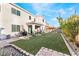 Spacious backyard with patio, grass, and rock features at 8595 Old Daylily Ln, Las Vegas, NV 89113