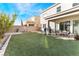 Large backyard with green grass and a patio area at 8595 Old Daylily Ln, Las Vegas, NV 89113