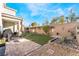 Landscaped backyard with a patio and grassy area at 8595 Old Daylily Ln, Las Vegas, NV 89113