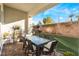 Covered patio with seating area and grassy backyard at 8595 Old Daylily Ln, Las Vegas, NV 89113