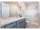 Bathroom with gray vanity, a large shower, and a toilet at 8595 Old Daylily Ln, Las Vegas, NV 89113