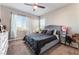 Spacious bedroom with a large bed and window view at 8595 Old Daylily Ln, Las Vegas, NV 89113