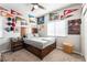 Well-lit bedroom featuring a full-size bed and wall decor at 8595 Old Daylily Ln, Las Vegas, NV 89113