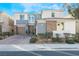 Two-story home with gray and stone accents, two-car garage, and landscaped front yard at 8595 Old Daylily Ln, Las Vegas, NV 89113