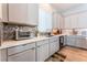 Modern kitchen with gray cabinets, quartz countertops, and mosaic backsplash at 8595 Old Daylily Ln, Las Vegas, NV 89113