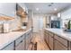 Open concept kitchen with stainless steel appliances and gray cabinetry at 8595 Old Daylily Ln, Las Vegas, NV 89113