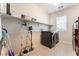 Bright laundry room with washer, dryer, and shelving at 8595 Old Daylily Ln, Las Vegas, NV 89113