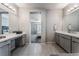 Main bathroom with double vanity and view into the main bedroom at 8595 Old Daylily Ln, Las Vegas, NV 89113