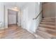 Modern staircase with wood-look treads and a metal railing at 8595 Old Daylily Ln, Las Vegas, NV 89113