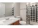 Bathroom with a vanity, toilet and a shower with black and white diamond patterned tile at 8809 Early Horizon Dr, Las Vegas, NV 89178