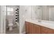 Bathroom features wood cabinets and black and white diamond patterned tile at 8809 Early Horizon Dr, Las Vegas, NV 89178