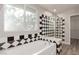 Bathroom with soaking tub and black and white tile at 8809 Early Horizon Dr, Las Vegas, NV 89178