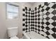 Bathroom with black and white diamond patterned tile and bathtub at 8809 Early Horizon Dr, Las Vegas, NV 89178