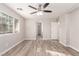 Bright bedroom featuring wood-look floors and a ceiling fan at 8809 Early Horizon Dr, Las Vegas, NV 89178