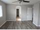 Spacious bedroom with wood-look floors and ceiling fan at 8809 Early Horizon Dr, Las Vegas, NV 89178