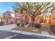 Two-story house with tan exterior, attached garage, and landscaping at 8809 Early Horizon Dr, Las Vegas, NV 89178