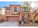 Two-story house with a two-car garage and landscaping at 8809 Early Horizon Dr, Las Vegas, NV 89178