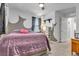 Bedroom with purple comforter and gray walls at 8862 Nannette Marie Ct, Las Vegas, NV 89148