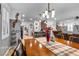 Spacious dining area with a large wooden table, view into kitchen and living room at 8862 Nannette Marie Ct, Las Vegas, NV 89148