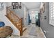 Inviting entryway with wood staircase, grey walls, and a decorative accent wall at 8862 Nannette Marie Ct, Las Vegas, NV 89148