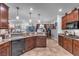 Well-equipped kitchen with dark wood cabinets and granite countertops at 8862 Nannette Marie Ct, Las Vegas, NV 89148