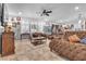 Bright living room featuring a comfortable sectional sofa and a ceiling fan at 8862 Nannette Marie Ct, Las Vegas, NV 89148