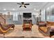 Relaxing living room with comfortable seating, fireplace, and large TV at 8862 Nannette Marie Ct, Las Vegas, NV 89148