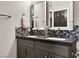 Modern bathroom with double vanity, gray cabinets, hexagon tile, and large mirrors at 9000 S Las Vegas Blvd # 2222, Las Vegas, NV 89123