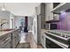 Modern kitchen with gray cabinets, stainless steel appliances, and purple accent wall at 9000 S Las Vegas Blvd # 2222, Las Vegas, NV 89123