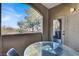 Covered patio with glass table and chairs and a view of the trees and sky at 9000 S Las Vegas Blvd # 2222, Las Vegas, NV 89123