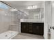 Modern bathroom with a large walk-in shower, dark cabinets, double sinks and neutral color palette at 9202 Valley Betica Ave, Las Vegas, NV 89148