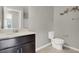 Clean bathroom with dark vanity, toilet and shower at 9202 Valley Betica Ave, Las Vegas, NV 89148