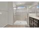 Contemporary bathroom featuring a glass-enclosed shower, updated fixtures, and tiled flooring at 9202 Valley Betica Ave, Las Vegas, NV 89148