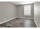 Simple bedroom featuring a light gray walls, hardwood floors and a window at 9202 Valley Betica Ave, Las Vegas, NV 89148