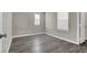 Well-lit bedroom featuring wood-look floors and window coverings at 9202 Valley Betica Ave, Las Vegas, NV 89148