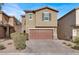 Two-story house with brown garage door and landscaped yard at 9202 Valley Betica Ave, Las Vegas, NV 89148