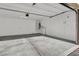 Spacious garage with concrete floor, white walls, and overhead lighting at 9202 Valley Betica Ave, Las Vegas, NV 89148