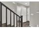 Hallway featuring grey walls, wood flooring, white doors and baseboards, with a staircase in the foreground at 9202 Valley Betica Ave, Las Vegas, NV 89148