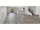 Spacious living room with grey wood-look floors at 9202 Valley Betica Ave, Las Vegas, NV 89148