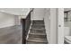 Modern stairs with dark gray wood-look flooring at 9202 Valley Betica Ave, Las Vegas, NV 89148